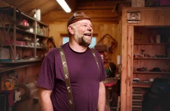 Man in shed laughing