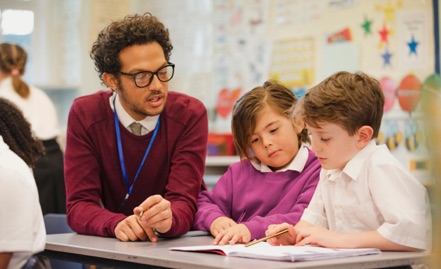 Teacher working with students