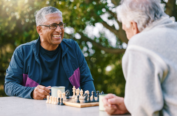 Mature man smiling playing chess